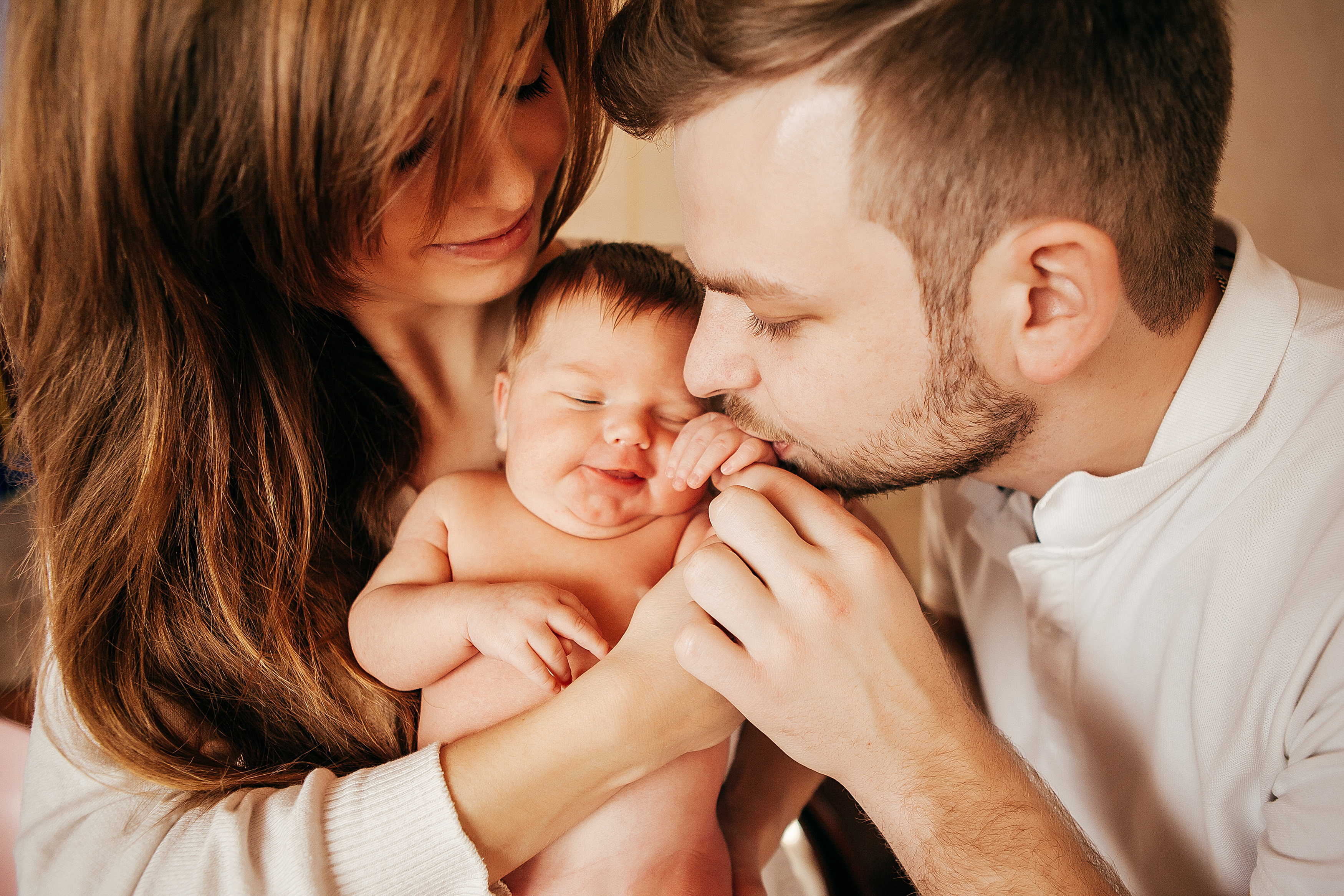 newborn-baby-arms-young-parents