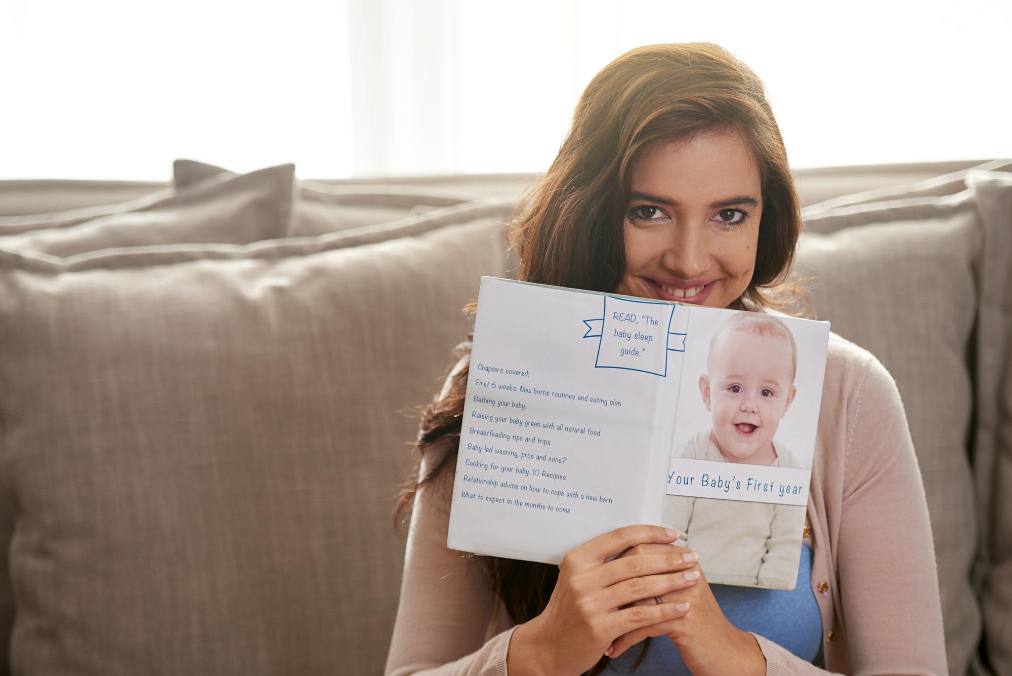 International parents holding newborn baby with Georgian birth certificate and passport documents on table