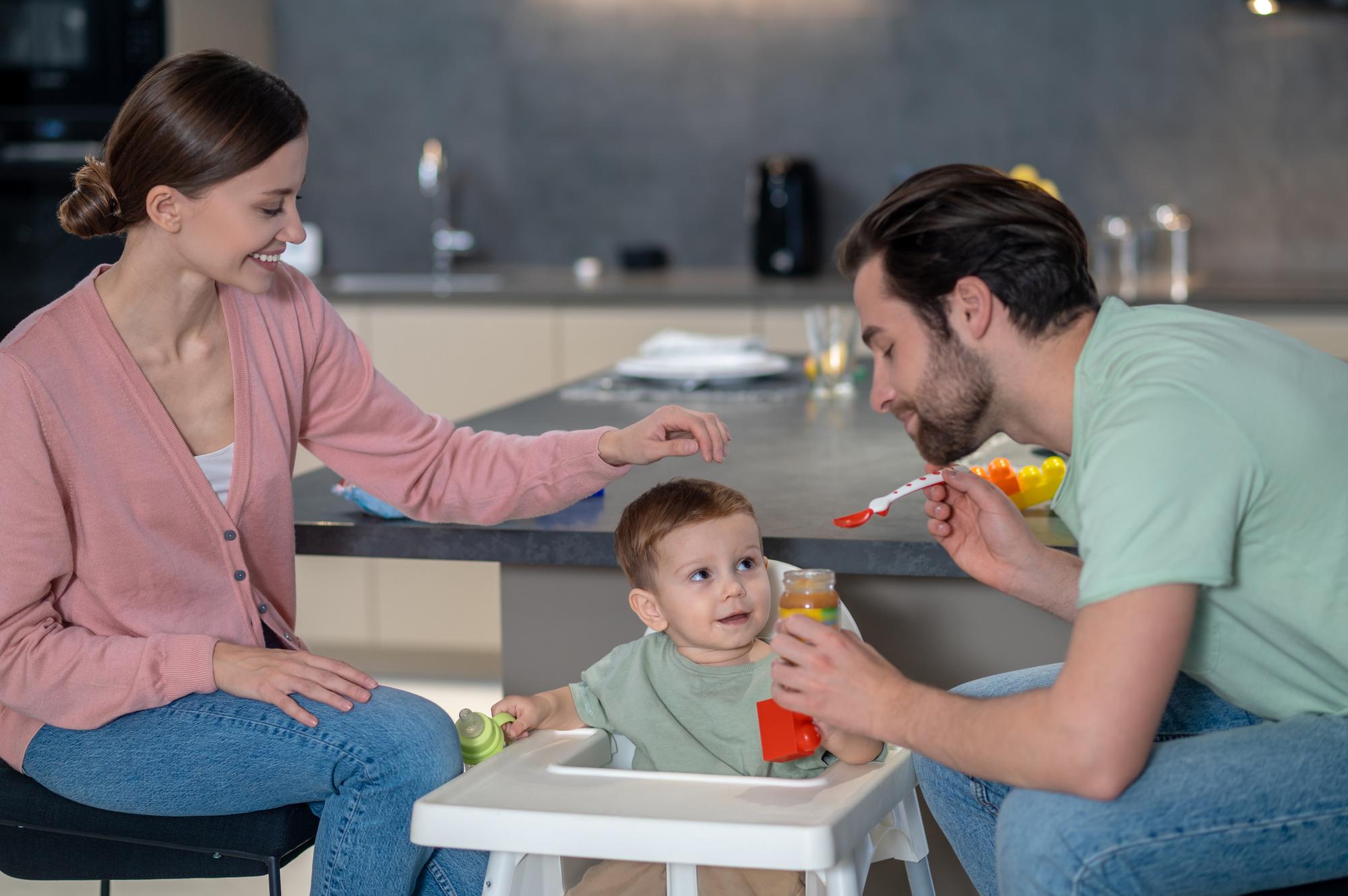 Pediatrician consulting with parents about baby formula feeding plan during home visit in Tbilisi