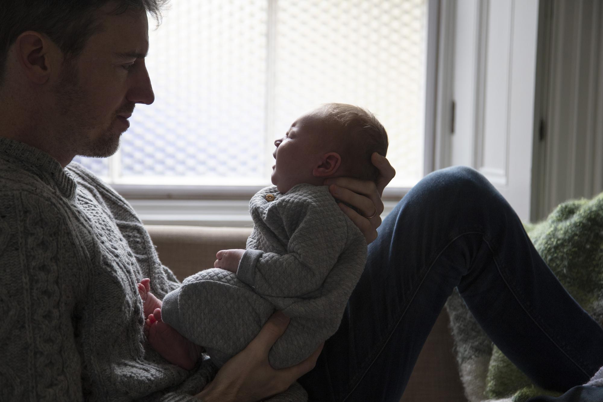 Peaceful baby being comforted by parent during crying episode