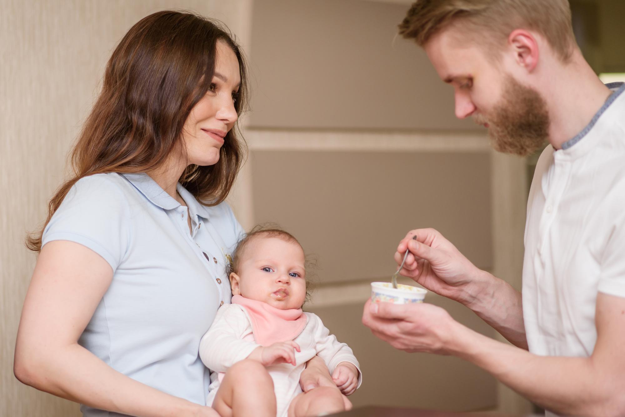 Pediatrician consulting with parents about formula feeding plan for their newborn baby