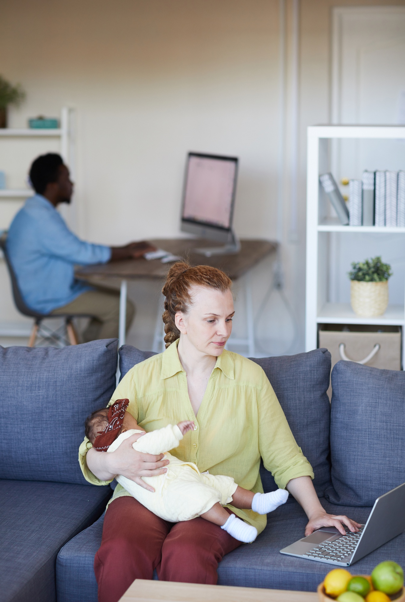 Medical lactation consultant providing breastfeeding support to mother and baby in Tbilisi home visit setting