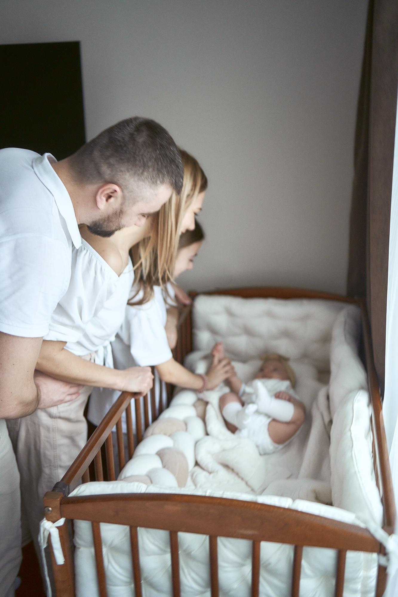 parents comfort their child in a cradle