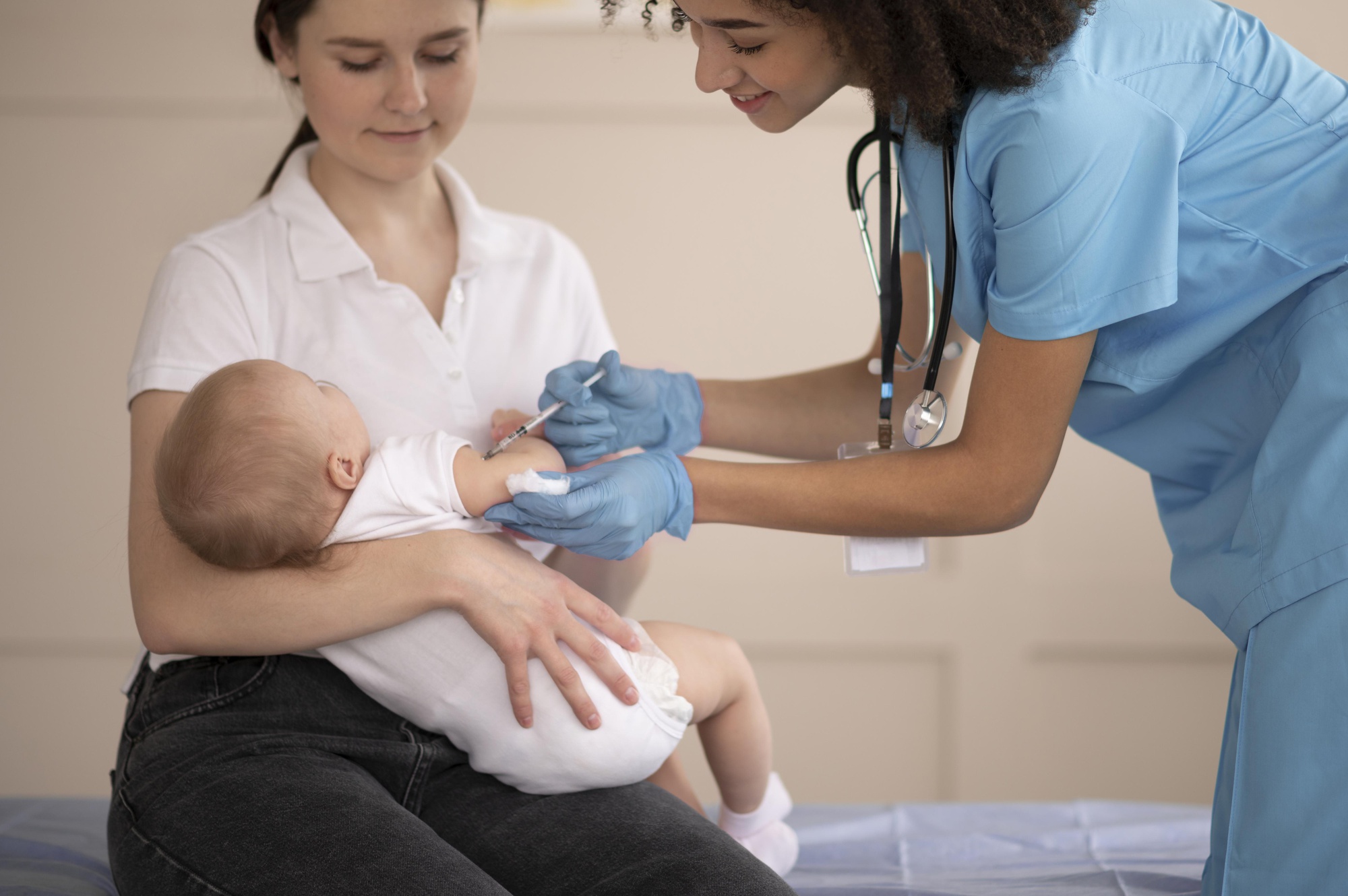 Newborn baby receiving vaccination with caring medical professional in Georgian healthcare setting