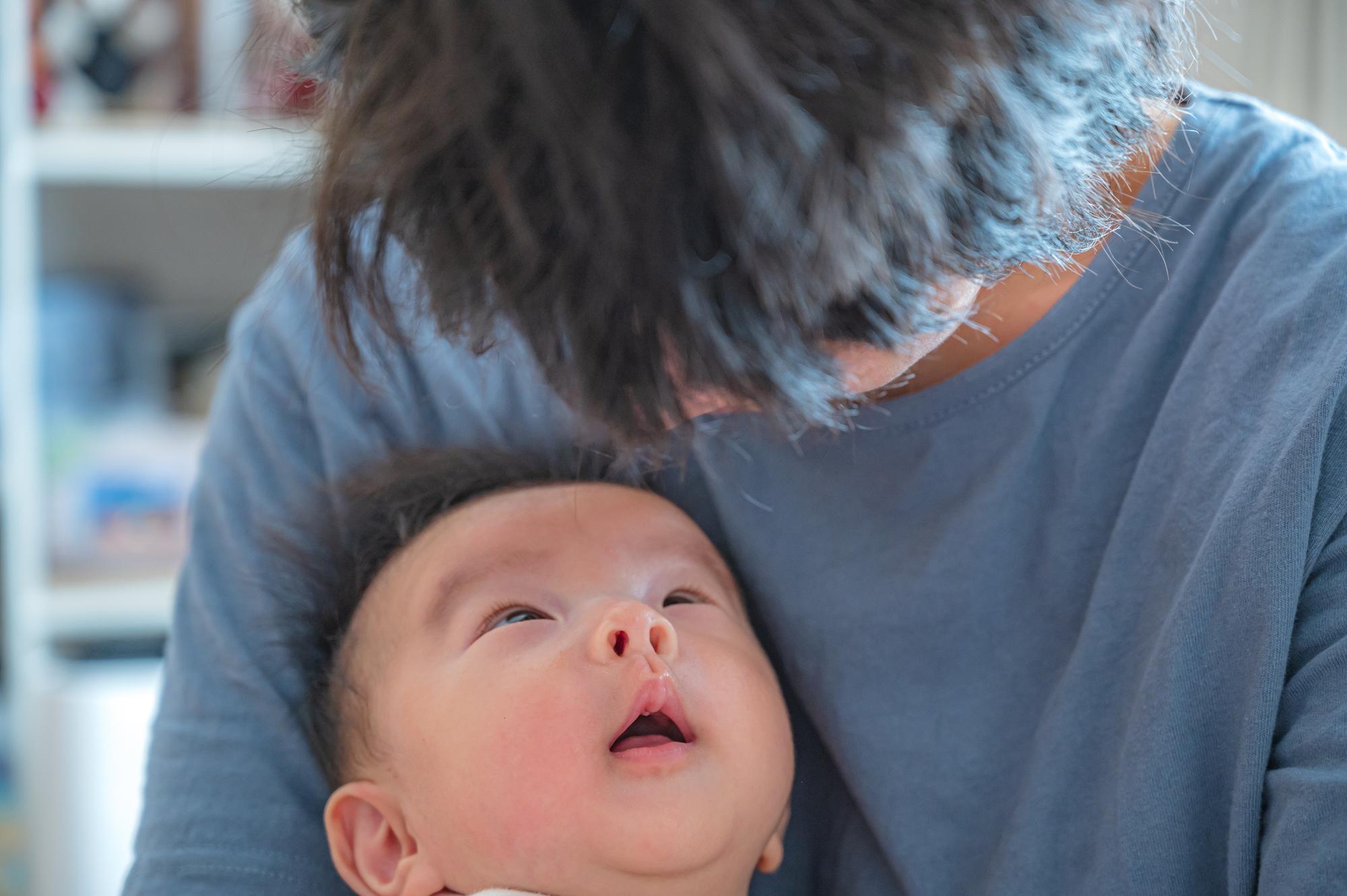 parent observing newborn symptoms carefully attentively